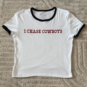 White Short Sleeve “I Chase Cowboys” Tee with Black Trim and Red Graphic